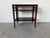 Elegant 1960s French Hollywood Regency three-tier side table crafted in rich mahogany with a warm, deep finish. Features a...