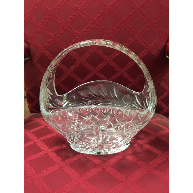 This lovely quality cut crystal glass handled basket features bright striking spectral highlights radiate from the profuse...