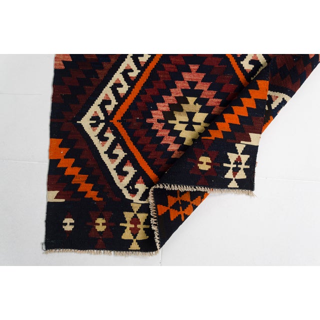 This is a vintage Turkish Oushak rug from the Mid 20th Century. The piece was hand-knotted.