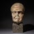 Fragmentary Roman male head depicting an elderly man with a receding hairline, pronounced eyebrows, strong cheek...