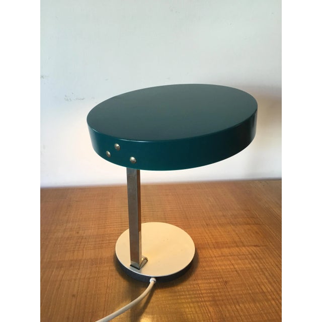 This is a simple and beautiful circular table lamp. The superior element is in metal with a green lacquer and the base is...