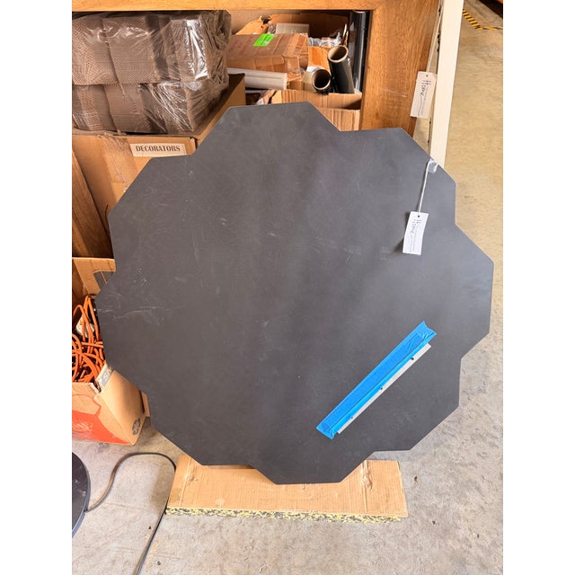 Art Deco–inspired octagonal mirror featuring a bold geometric frame in glossy black and warm bronze-gold tones. The...