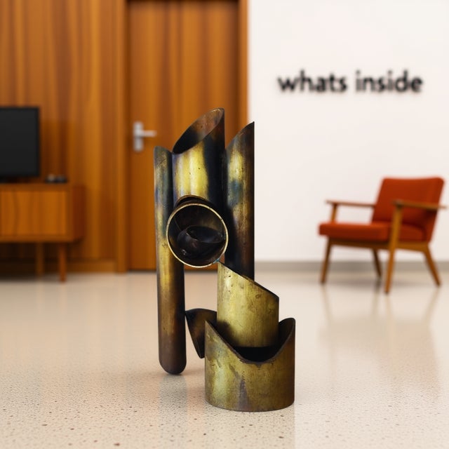 Striking modernist metal sculpture with dramatic verticality and architectural presence. Constructed from brass-finished...