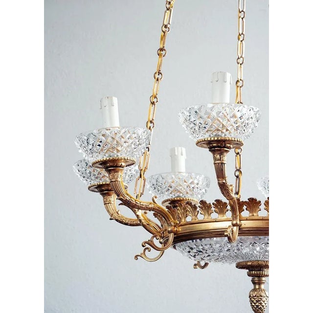 Antique French Napoleon III chandelier in gilded bronze and crystal. The circular part holds eight arms interspersed with...