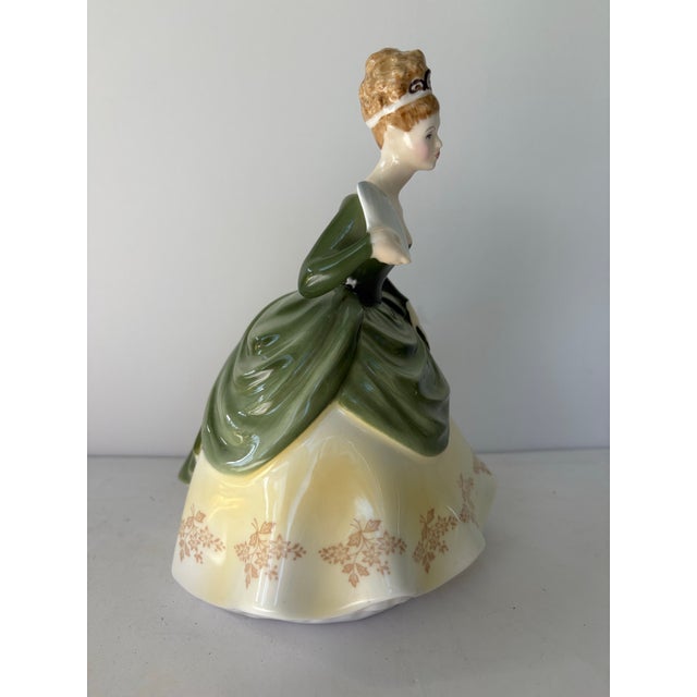 This elegant vintage porcelain figurine is “Soirée,” model HN 2312, produced by Royal Doulton and copyrighted in 1966. The...