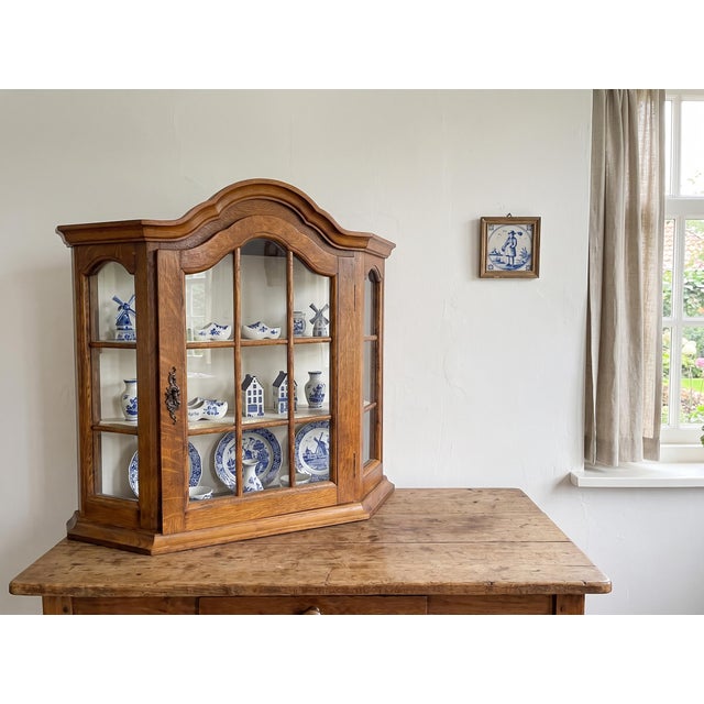 Authentic Dutch mid-century wall-mounted display cabinet / curio vitrine, crafted in the Netherlands during the 1950s from...