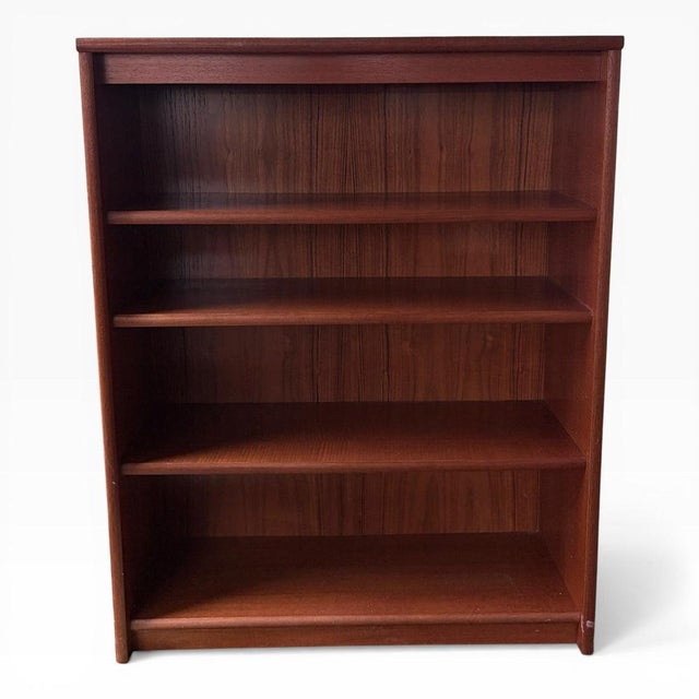 A classic mid-century Danish teak bookcase, showcasing the clean lines and understated elegance typical of Scandinavian...
