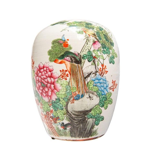 A Chinese famille rose porcelain jar featuring traditional phoenix and peony decoration with calligraphic script to the...