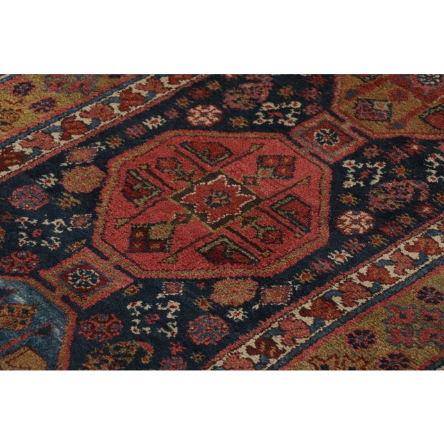 Hand-knotted in wool and originating from turkey circa 1950-1960, this 3x14 vintage runner rug features a design that...