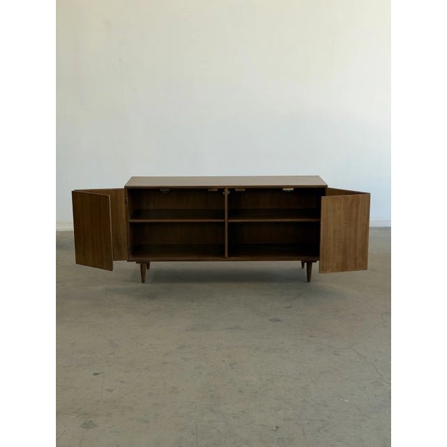 W59 D18 H30 Fully restored minimal Credenza with lots of open storage behind doors. Item features new wooden legs with...