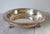 Vintage footed silverplate serving bowl features a classic round shape, an ornate rim, and decorative claw and shell feet....