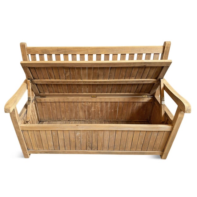 Classic outdoor teak wood bench with arms and slatted back. Seat lifts up to reveal spacious trunk storage area. Each may...