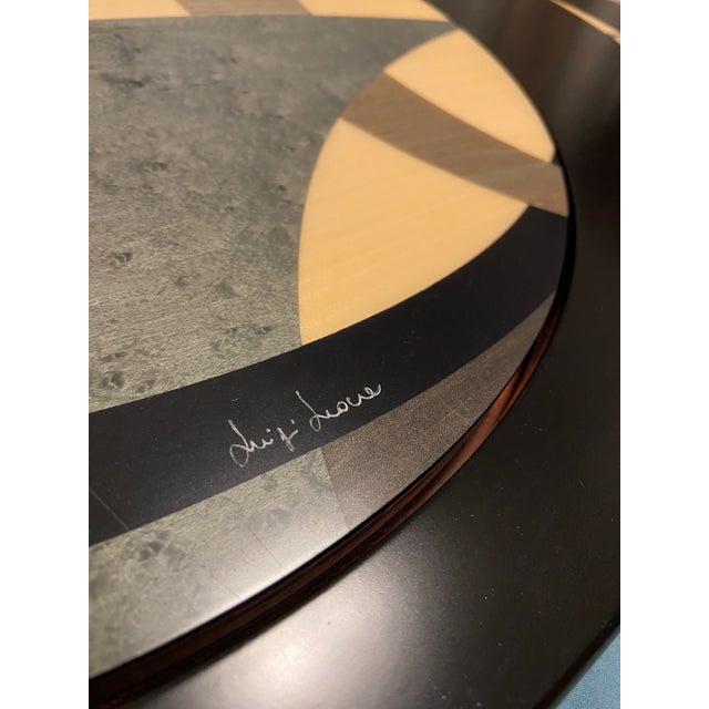 An exceptional example of traditional Italian tarsia lignea (wood marquetry), this rare mechanical expanding oval table...