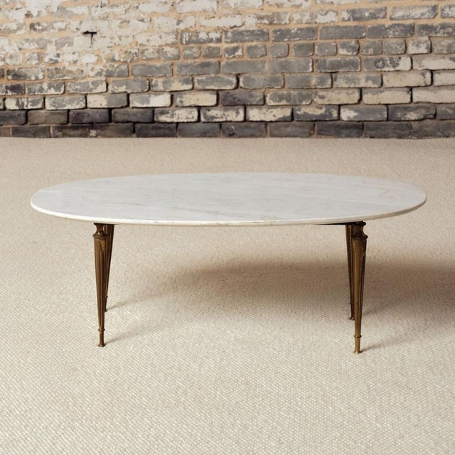 Add refined mid-century elegance to your space with this 1950s French marble top coffee table, a beautifully balanced...