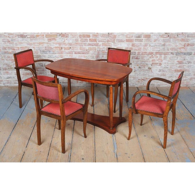 This set of four luxurious dining armchairs is a magnificent example of high French Art Deco from the 1930s. The...