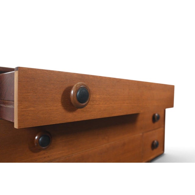 This low six-drawer dresser was made in England during the 1960s. The teak case features leather drawer pulls, adding a...
