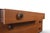 This low six-drawer dresser was made in England during the 1960s. The teak case features leather drawer pulls, adding a...