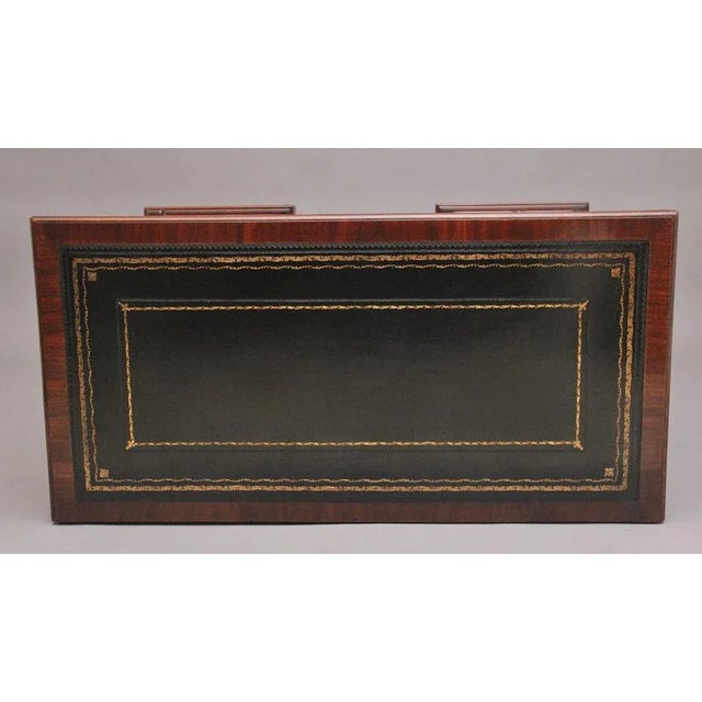 Early 19th Century mahogany kneehole desk, the rectangular moulded edge top having a black leather writing surface...