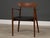 A mid century modern solid teak chair with original black leather by Harry Østergaard for A/S Randers Møbelfabrik. Made in...