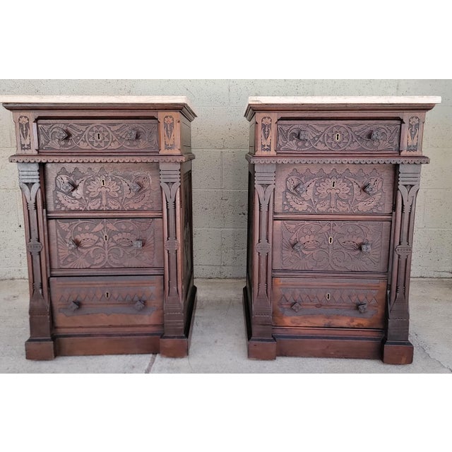 Exceptional detail and craftsmanship to this pair of Aesthetic Movement night stands. Hand-Carved stylized flora and fauna...