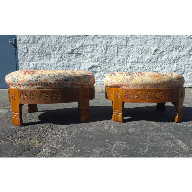Intricate designed pair of Boho Moroccan inspired ottomans. The pair features a simply carved wood base and colorful pouf...
