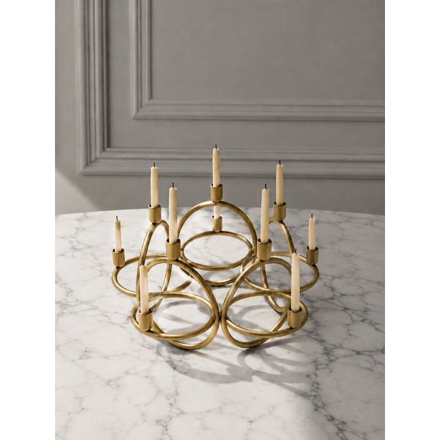 An exceptional mid-century modern ten-light candelabra crafted from solid brass and composed of five circular elements...