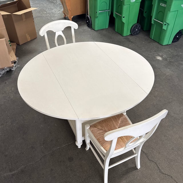 Design Plus Gallery presents the Shayne Drop Leaf Table + Pair of Napoleon Chairs Set from Pottery Barn. The expandable...