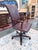 A distinguished Hancock & Moore executive desk chair upholstered in rich burgundy leather with a refined tailored...