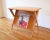 This is a beautiful mid century modern side end table by Heywood Wakefield, circa 1950s. It has a built in magazine rack...