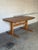 This extendable dining table features a smooth top and a trestle base designed for effortless seating. It delivers classic...