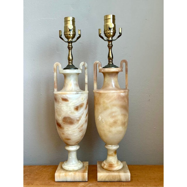 These striking table lamps capture the timeless elegance of Neoclassical design, expertly sculpted into an amphora-...