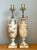 These striking table lamps capture the timeless elegance of Neoclassical design, expertly sculpted into an amphora-...