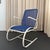 This Mid-Century Modern patio armchair features a striking, white-painted steel cantilever frame that provides a subtle,...