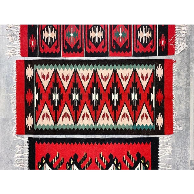 1960's Hand-woven Danish wool wall tapestries feature traditional geometric patterns in red, black, and white. The...