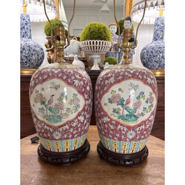 Absolutely lovely pair of famille rose, heavily-enameled ginger jar lamps in beautiful condition. Colors is a shade of...