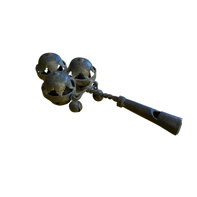 An exceptional antique handcrafted brass rattle whistle that beautifully combines decorative artistry with traditional...