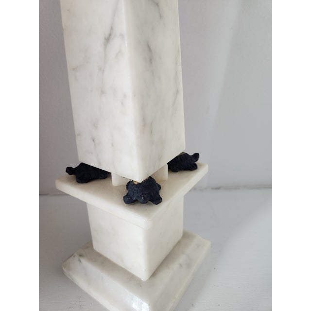 A rare and charming Italian white alabaster obelisk featuring tiny carved turtles nestled along each side of the base....