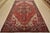 An authentic vintage tribal Heriz rug hand-knotted with fine wool and natural dyes. This nomadic rug features a central...