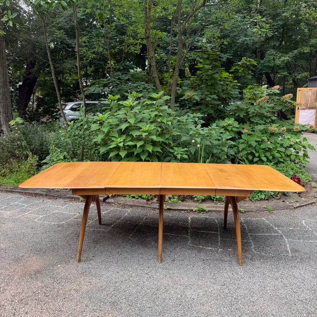 Crafted from warm birch, this Heywood-Wakefield Wishbone drop-leaf dining table pairs sculptural lines with everyday...