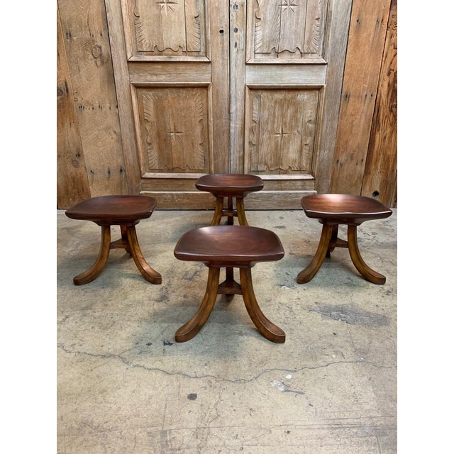 Three legged tractor style seated stools in the style of Adolf Loos. The seats are sculpted of one piece of mahogany.