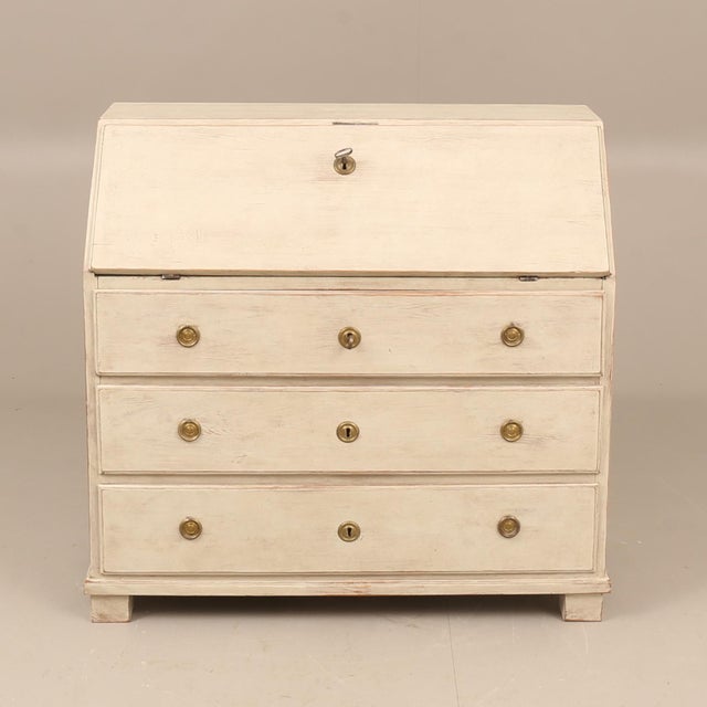 A beautifully restrained Swedish secretary desk in the Gustavian tradition, featuring a slant-front writing surface over...