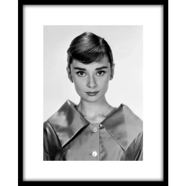 Audrey Hepburn, circa 1957. 11" x 14" silver gelatin fiber based print. Signed by photographer Bud Fraker. Printed under...