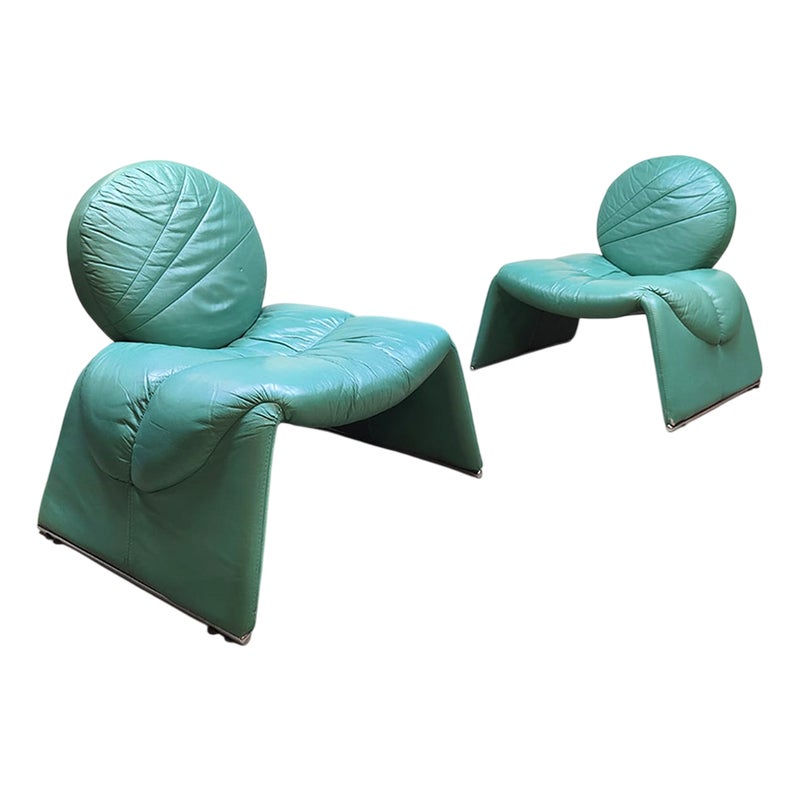 Two green leather chairs with unique design