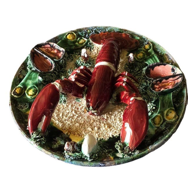 Original and wonderfully vintage, this large majolica earthenware platter features a trompe-l'oeil decoration of a...