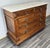 This elegant Antique French chest of drawers is a beautifully crafted piece, combining rich carved detailing with a...
