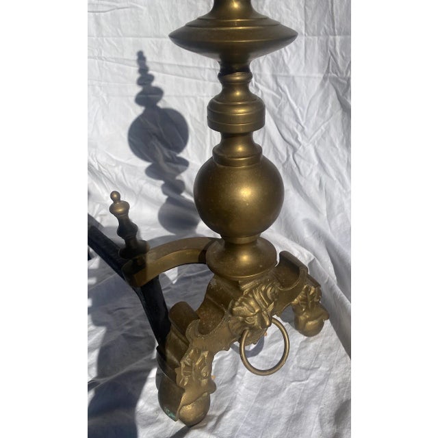 Set of two brass andirons in original condition (see pictures of patina spots). Lion head detail on the front of both....