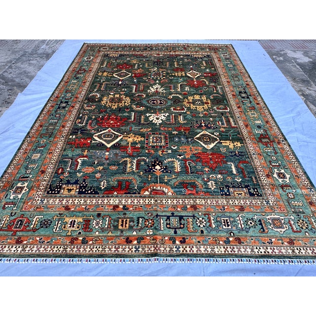 This magnificent hand-knotted wool area rug showcases an authentic, highly detailed Afghan Kazak design. The large center...