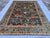 This magnificent hand-knotted wool area rug showcases an authentic, highly detailed Afghan Kazak design. The large center...