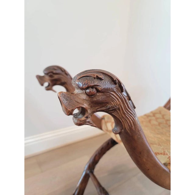 A exceptionally carved Italian Renaissance Revival figural curule stool. Born in Italy during the late 19th century, hand-...