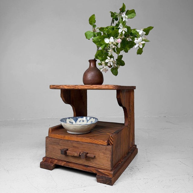 Small Japanese display cabinet from the 1950s–1960s, made of sugi, Japanese cedar. The piece has a compact form with one...
